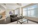 Cozy living room featuring sleek tile flooring, modern furnishings, and ample natural light from large windows at 211 Cosmopolitan Ct # 211, Sarasota, FL 34236