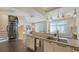 Open concept living space with kitchen, elevator, and contemporary decor at 211 Cosmopolitan Ct # 211, Sarasota, FL 34236