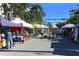 Lively outdoor market with vendors and shoppers on a sunny day at 211 Cosmopolitan Ct # 211, Sarasota, FL 34236