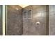 Sleek shower featuring dark tile walls, and modern fixtures at 211 Cosmopolitan Ct # 211, Sarasota, FL 34236