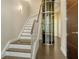 Staircase with modern glass elevator provides an easy way to move between floors in style at 211 Cosmopolitan Ct # 211, Sarasota, FL 34236