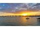 Beautiful sunset over the bay with a sailboat, evoking tranquility and scenic views at 211 Cosmopolitan Ct # 211, Sarasota, FL 34236