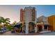 Charming theater exterior with marquee, lighted signs, and colorful potted plants in a sidewalk setting at 211 Cosmopolitan Ct # 211, Sarasota, FL 34236