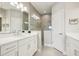 Bathroom featuring double sinks, neutral walls, and glass shower door at 244 Tracino Ter, Nokomis, FL 34275