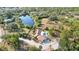A high angle view showing the house with a backyard pool, adjacent to a lake and ample greenery at 265 Beaver Ct, Venice, FL 34292