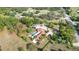 Aerial shot of a private estate featuring a home with pool, a pond, and mature trees, nestled within lush landscaping at 265 Beaver Ct, Venice, FL 34292