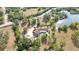 Aerial shot of estate featuring a pool, and landscaped grounds, nestled among mature trees at 265 Beaver Ct, Venice, FL 34292