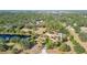 An aerial view of the property showcasing the sprawling acreage with lush tree coverage and pond at 265 Beaver Ct, Venice, FL 34292