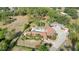 An aerial view of the house, showcasing a backyard pool, mature trees, and expansive driveway at 265 Beaver Ct, Venice, FL 34292