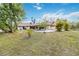 Backyard with in-ground pool, covered patio and mature landscaping at 265 Beaver Ct, Venice, FL 34292