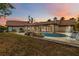 Backyard with in-ground pool, rock waterfall, and covered patio at 265 Beaver Ct, Venice, FL 34292