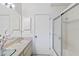 Bathroom with single sink, white tile shower, and framed mirror at 265 Beaver Ct, Venice, FL 34292