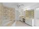 Bathroom with marble tub, dual sink vanity and palm tree wallpaper at 265 Beaver Ct, Venice, FL 34292