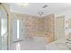 Bathroom with a corner tub, shower with glass doors, and leaf-patterned wallpaper at 265 Beaver Ct, Venice, FL 34292