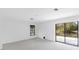 Empty room featuring a sliding glass door and a window at 265 Beaver Ct, Venice, FL 34292