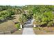 Gated concrete driveway lined with mature palms and leading up to the residence at 265 Beaver Ct, Venice, FL 34292