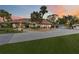 Lovely single-story home featuring a tile roof, mature landscaping, and an expansive driveway leading to a three-car garage at 265 Beaver Ct, Venice, FL 34292