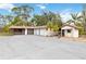 Exterior view of a detached three-car garage and workshop with paved driveway at 265 Beaver Ct, Venice, FL 34292
