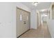 Hallway with tile flooring, closet, and white double doors with glass pane detailing at the front entrance at 265 Beaver Ct, Venice, FL 34292