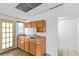 A galley kitchen featuring upper and lower cabinets and a window for natural light at 265 Beaver Ct, Venice, FL 34292