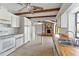 Bright kitchen with white cabinets, wooden countertops, tiled flooring, and ceiling fan with wooden beam accents at 265 Beaver Ct, Venice, FL 34292