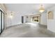 Bright living room with large windows, stylish lighting, and views of nature at 265 Beaver Ct, Venice, FL 34292