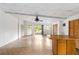 Expansive living space featuring a sliding glass door and neutral walls with a half wall kitchen at 265 Beaver Ct, Venice, FL 34292