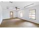 A spacious room featuring carpet flooring, neutral walls and two large windows at 265 Beaver Ct, Venice, FL 34292