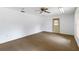 Carpeted room with neutral walls, natural light, and easy access to the outdoors at 265 Beaver Ct, Venice, FL 34292