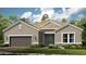Charming single-story home with a two-car garage, landscaped yard, and neutral colored facade at 26891 Victoria Pl, Punta Gorda, FL 33955