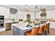 Modern kitchen features an island with seating, stainless steel appliances, and white cabinets at 26891 Victoria Pl, Punta Gorda, FL 33955