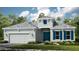 Charming single-story home with a well-manicured lawn, blue shutters, and a gray roof at 26896 Victoria Pl, Punta Gorda, FL 33955
