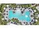 Aerial view of an uniquely designed pool with plenty of seating and umbrellas surrounded by palm trees at 26902 Victoria Pl, Punta Gorda, FL 33955