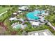Aerial view of luxurious pool area surrounded by lush landscaping, lounge seating and cabanas at 26930 Lark Ct, Punta Gorda, FL 33955
