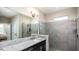 Contemporary bathroom featuring a granite countertop, glass-enclosed shower, and modern fixtures at 26931 Lark Ct, Punta Gorda, FL 33955