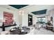 Elegant dining and living space featuring modern chandelier, decorative ceiling, and stylish decor at 26936 Lark Ct, Punta Gorda, FL 33955