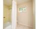 Bathroom area showcases a shower over tub combination and natural light from window at 2903 Mayflower St, Sarasota, FL 34231