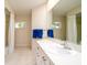 Bright bathroom with double shower, large mirror, and blue towels hanging at 2903 Mayflower St, Sarasota, FL 34231