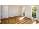 Well lit bedroom features laminate flooring, a door, and a garden view at 2903 Mayflower St, Sarasota, FL 34231