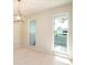 Bright dining room with tile floors, neutral walls, and two windows at 2903 Mayflower St, Sarasota, FL 34231