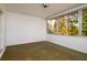 Relaxing sunroom offers light and space with multiple windows and garden views at 2903 Mayflower St, Sarasota, FL 34231
