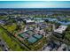 Wide aerial shot showing pickleball courts, community center, and surrounding neighborhood at 303 Grayston Pl # C133, Sun City Center, FL 33573
