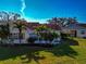 Aerial view of a home showcasing the lush lawn, tropical landscaping, and screened lanai at 303 Grayston Pl # C133, Sun City Center, FL 33573
