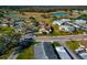 Aerial view of a residential area with single-Gathering homes, a street, and mature trees at 303 Grayston Pl # C133, Sun City Center, FL 33573