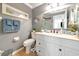 Charming bathroom featuring a white vanity, gray walls, and coastal-themed decor at 303 Grayston Pl # C133, Sun City Center, FL 33573