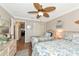 Bright bedroom featuring two twin beds, wood floors, and coastal-themed decor at 303 Grayston Pl # C133, Sun City Center, FL 33573