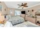Comfortable bedroom with twin beds, ceiling fan, and beachy-themed decor for a relaxing coastal vibe at 303 Grayston Pl # C133, Sun City Center, FL 33573