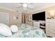 Bedroom featuring a comfortable bed and coastal decor at 303 Grayston Pl # C133, Sun City Center, FL 33573