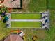 Aerial view of bocce ball courts bordered by landscaping and seating areas at 303 Grayston Pl # C133, Sun City Center, FL 33573