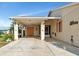 Covered carport featuring dolphin paintings and decorated with pelican and seashell art at 303 Grayston Pl # C133, Sun City Center, FL 33573